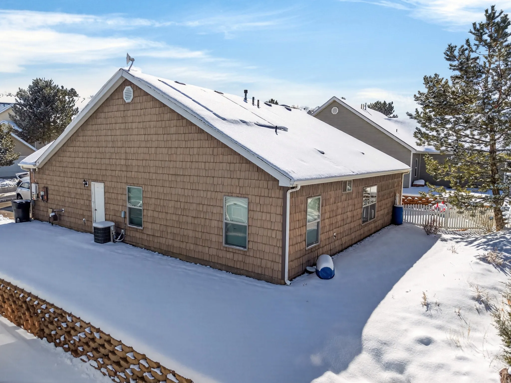View of snowy exterior with a central air condition unit
