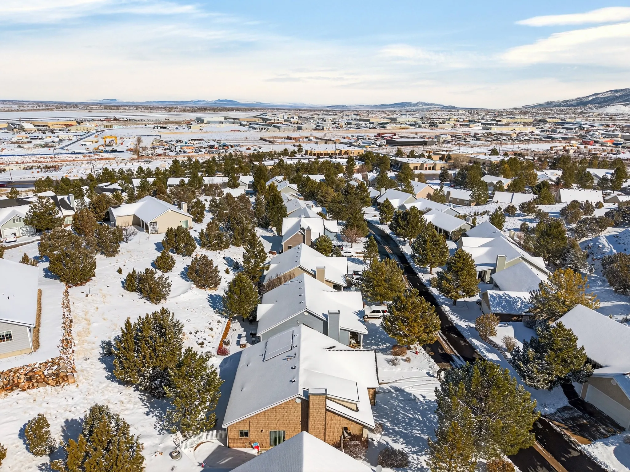 Snowy aerial view with a mountain view and a residential view