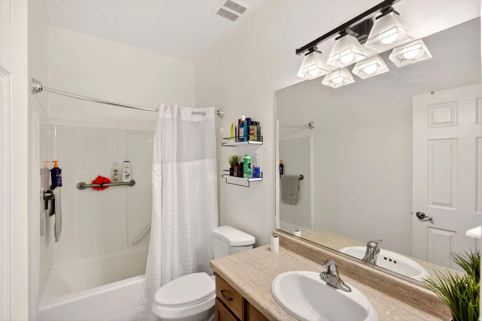 Full bath with vanity and shower / tub combo with curtain