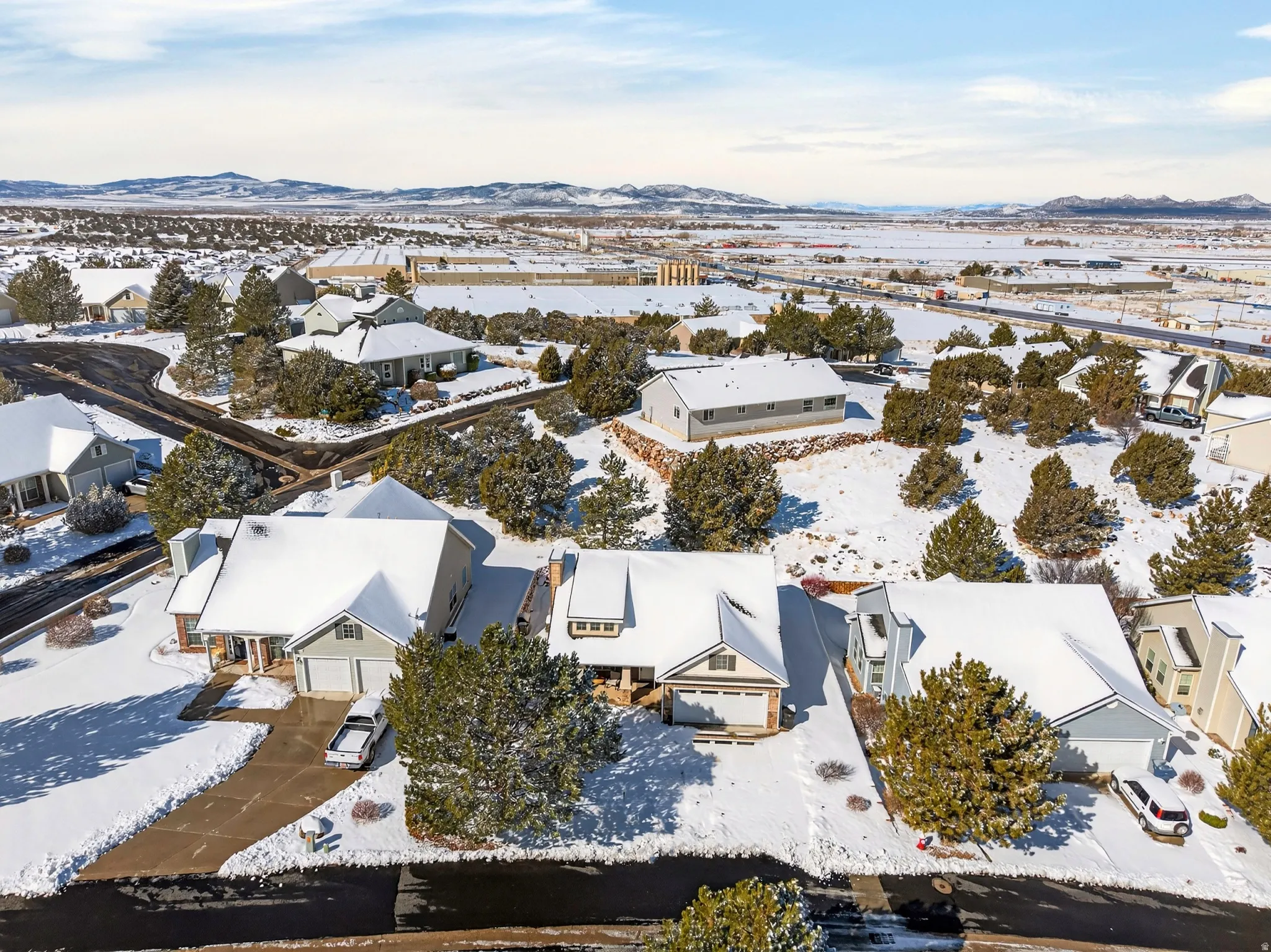 Snowy aerial view with a residential view and a mountain view