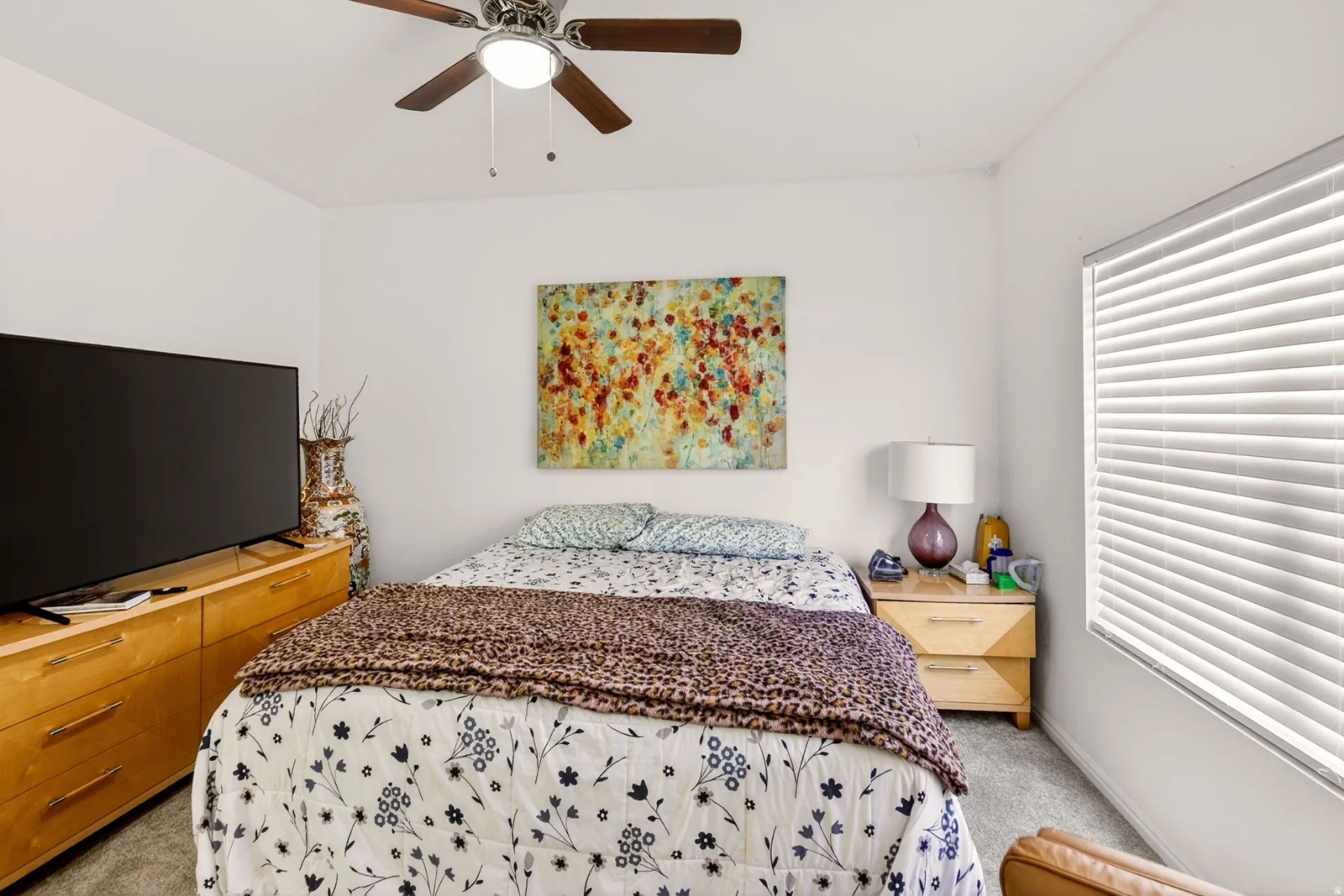 Bedroom featuring light carpet and a ceiling fan