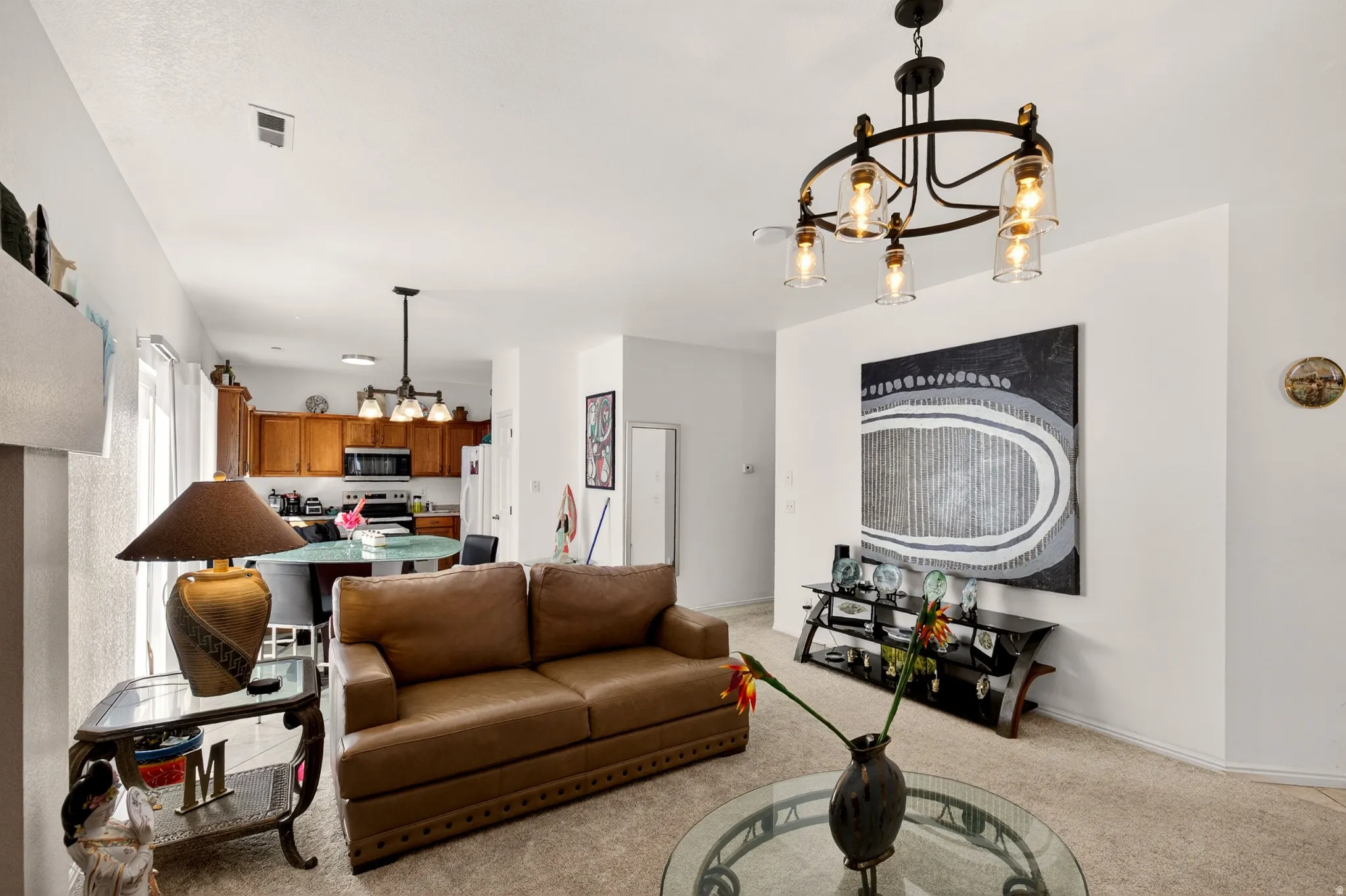 Living area with hanging lights and light carpet