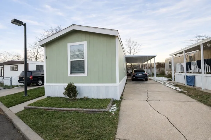 View of home's exterior featuring a carport and concrete driveway