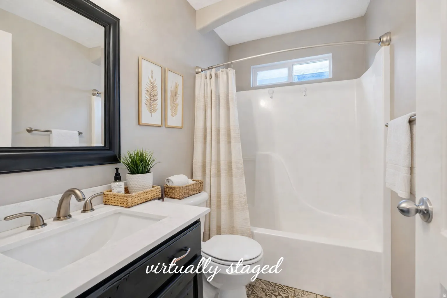 Bathroom featuring vanity and shower / bath combination with curtain