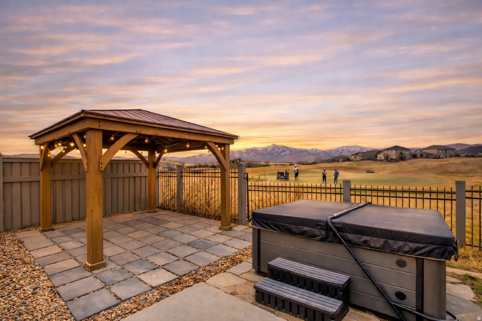 Patio terrace at dusk featuring a patio, a gazebo, a fenced backyard, a mountain view, and a hot tub