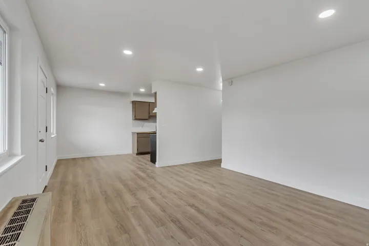Family room with light wood-style floors and recessed lighting