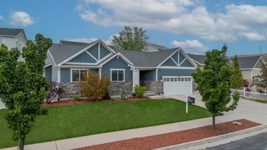 Contemporary ranch home featuring a blue siding exterior with stone accents