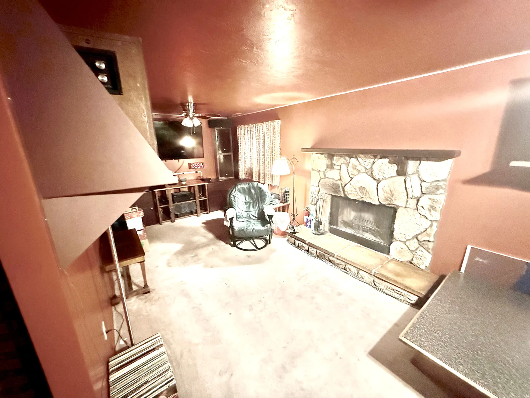 Living area with a fireplace, ceiling fan,