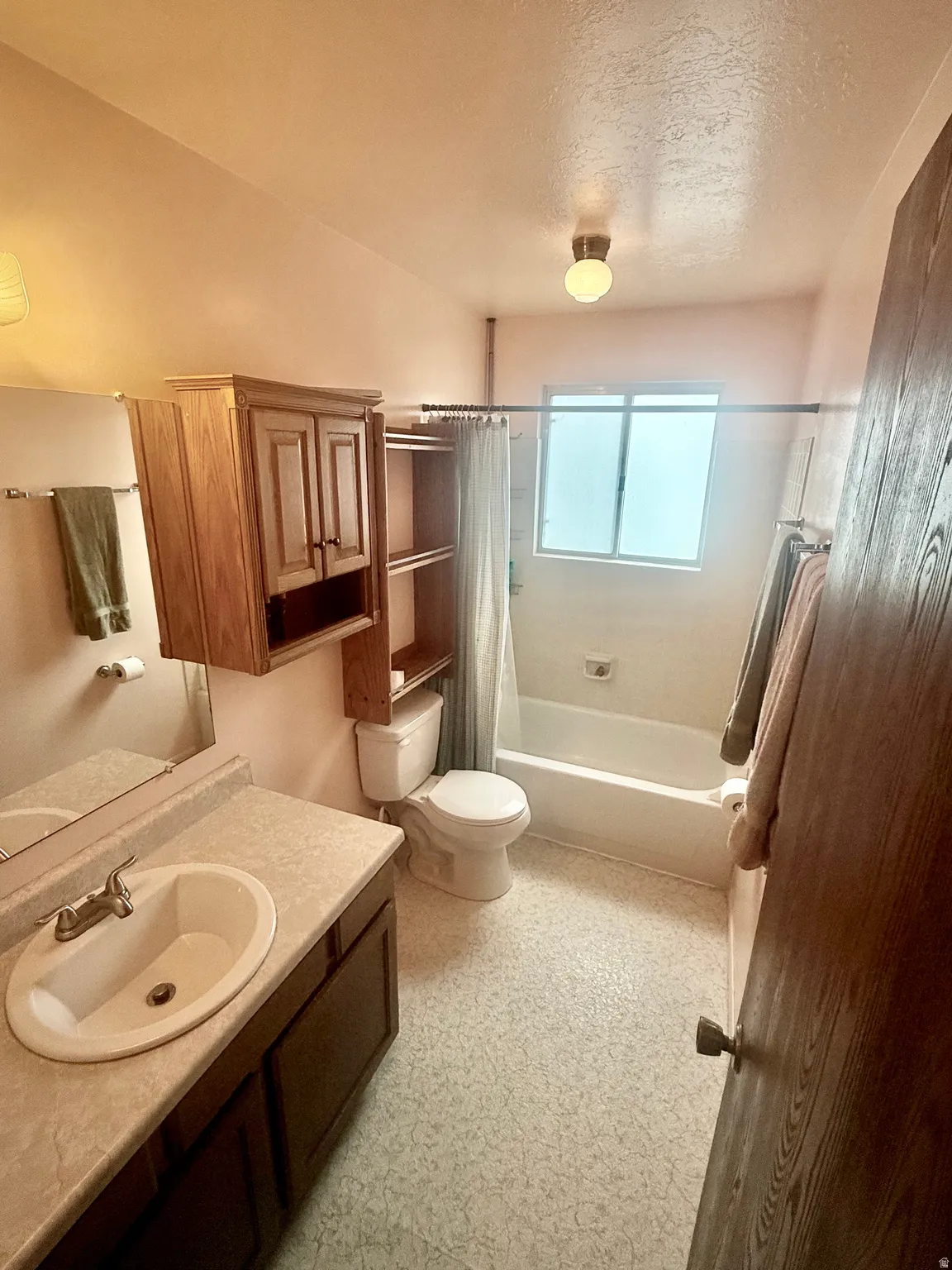 Full bath with vanity, shower / bath combo