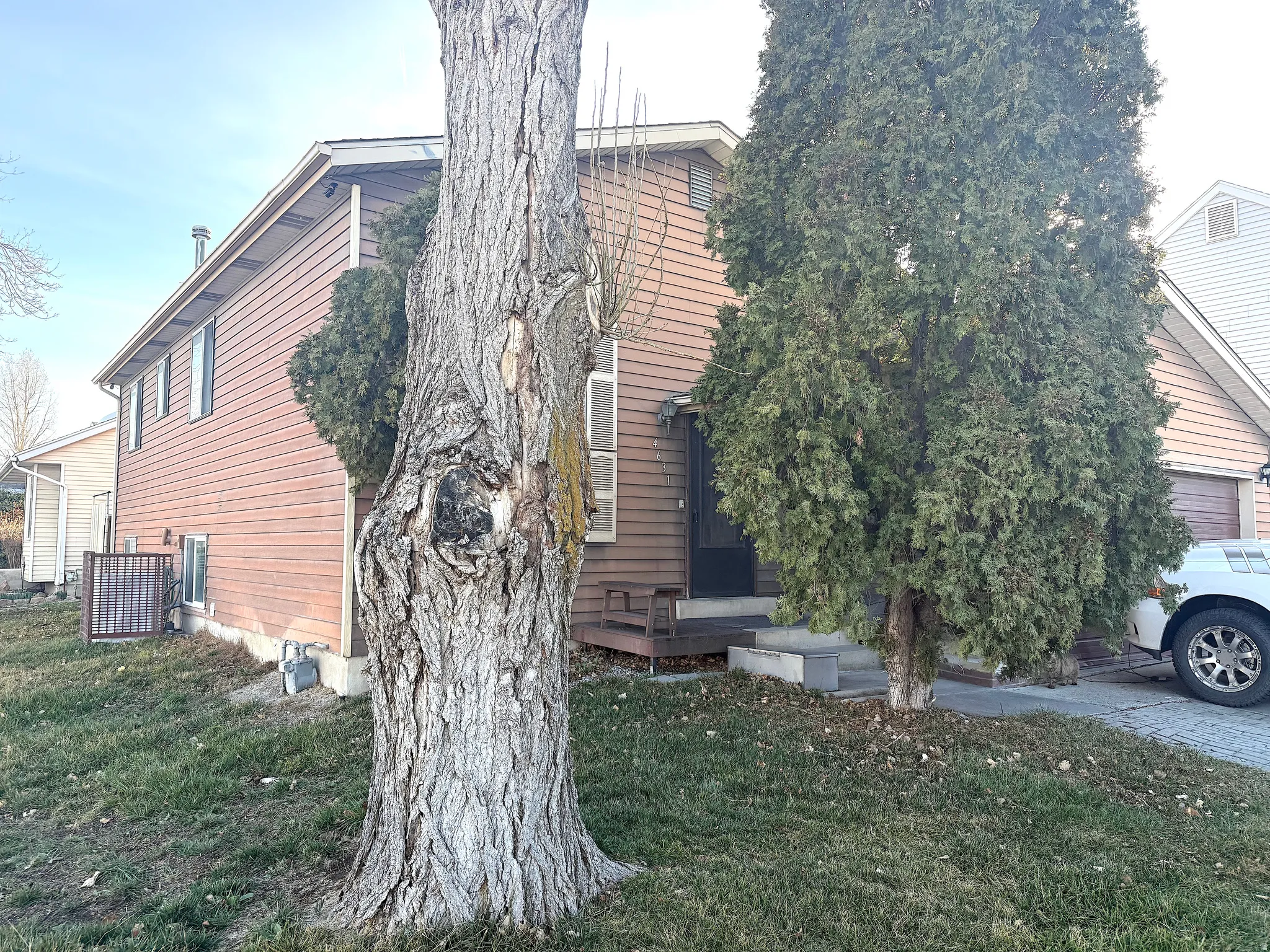 View of home's exterior with a yard and a garage