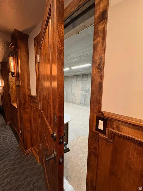 Detailed view of carpet floors and wood walls