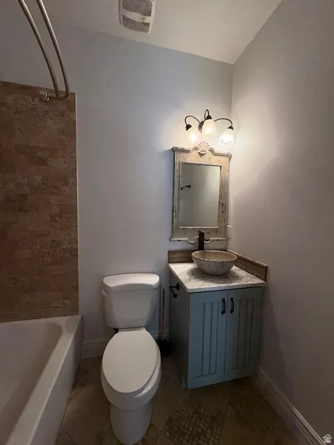 Bathroom with vanity, tile patterned flooring, and tub / shower combination