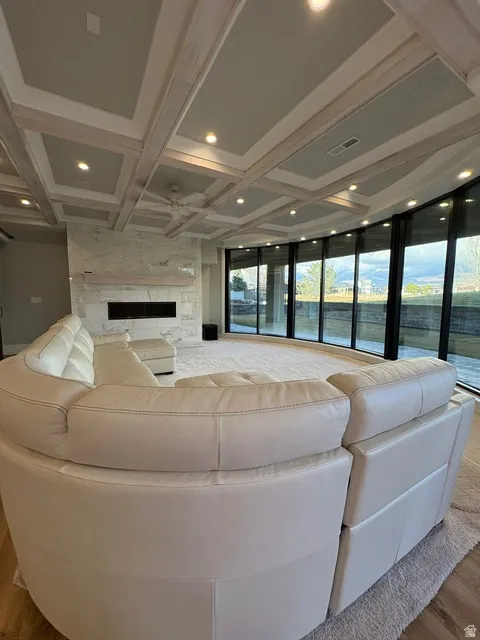 Living area with coffered ceiling, a fireplace, and recessed lighting