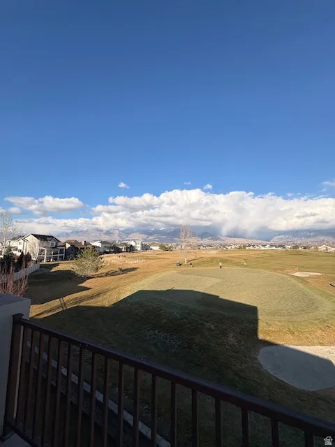 View of green lawn featuring a balcony