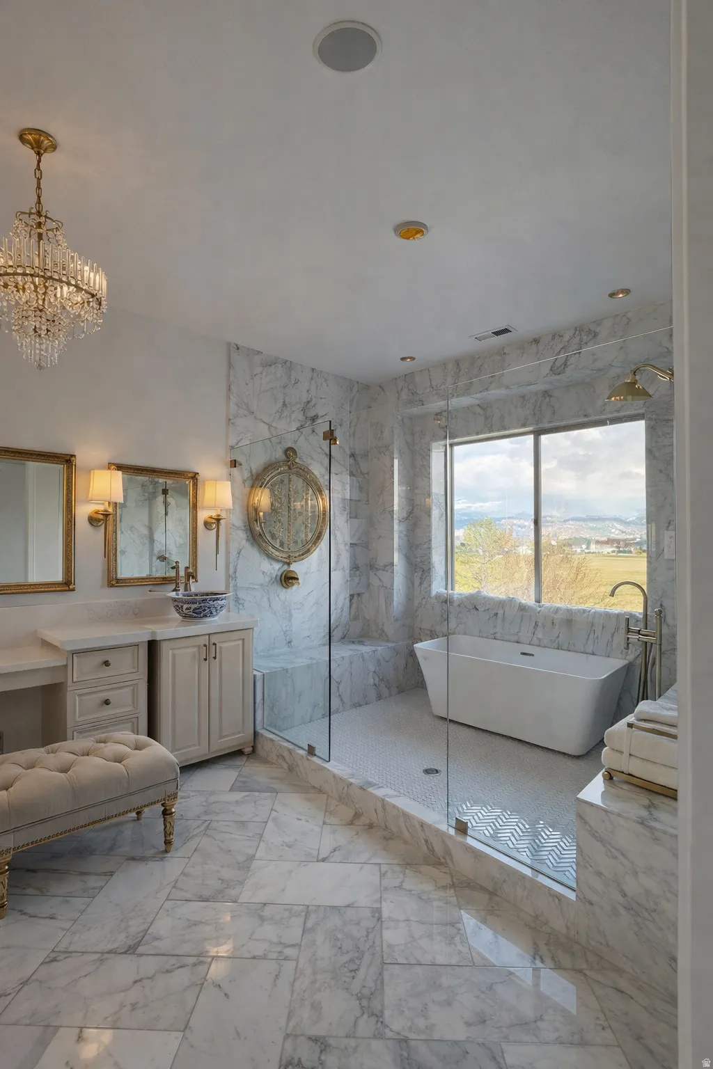 Full bathroom with vanity, a soaking tub, a marble finish shower, suspended lighting, and light marble finish floors