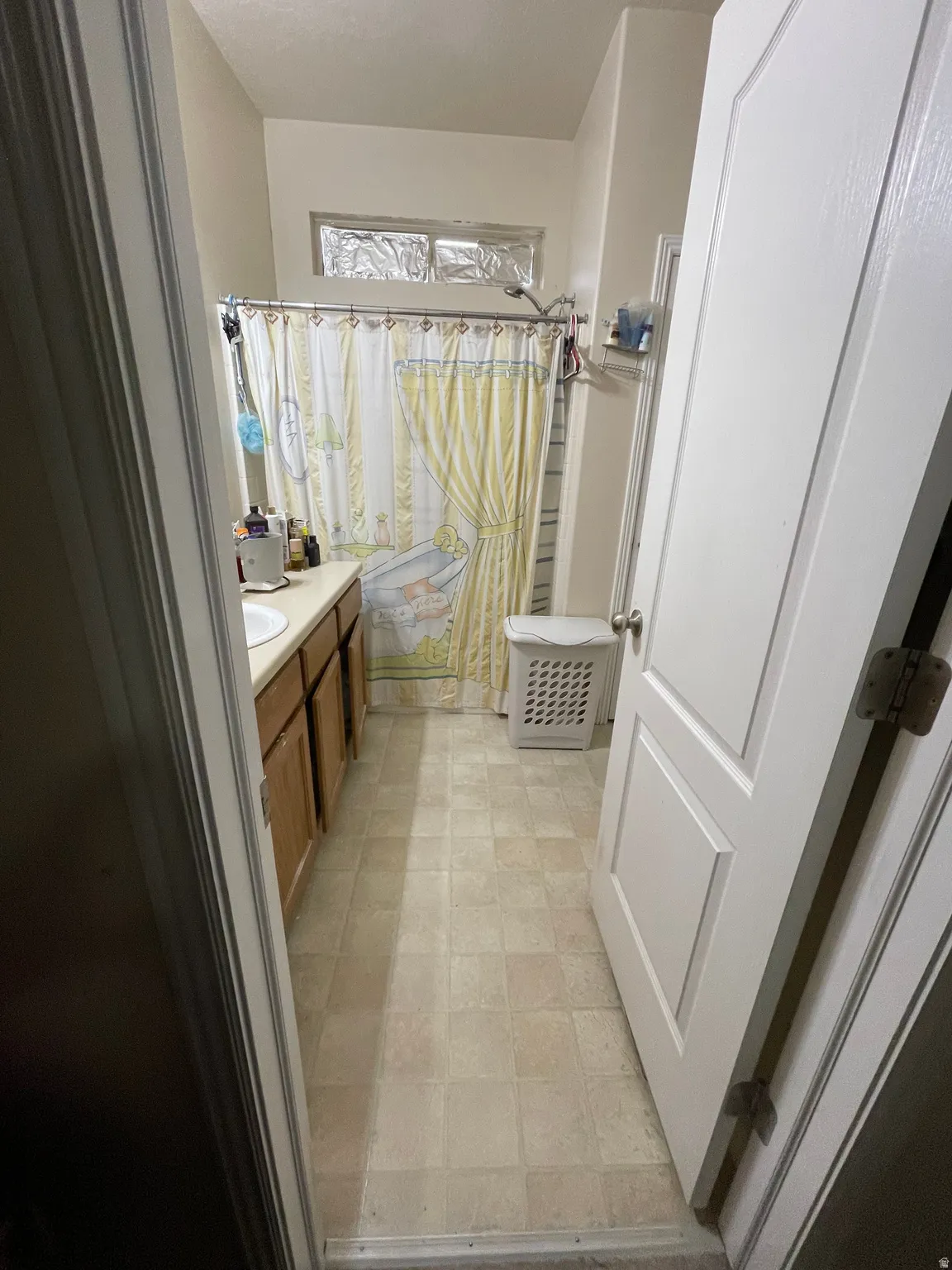 Full bath featuring vanity and shower / bath combo with shower curtain