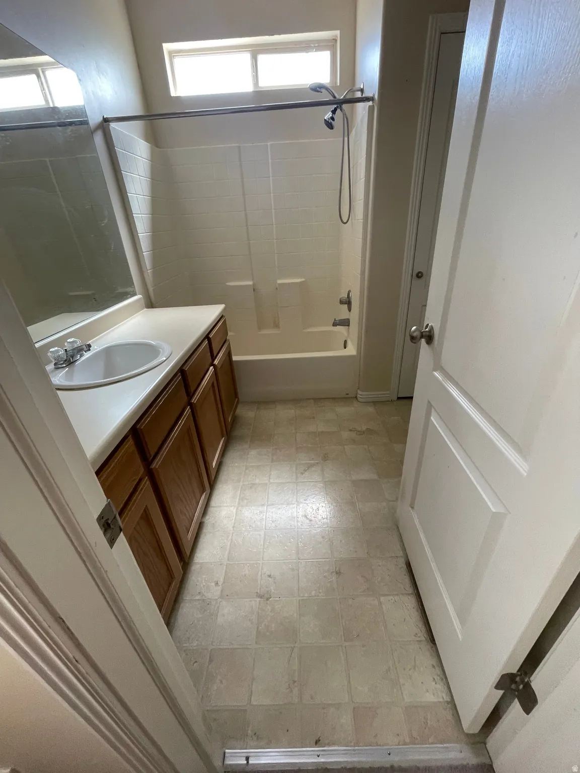 Bathroom featuring a single vanity with wood-finish cabinetry and a white countertop