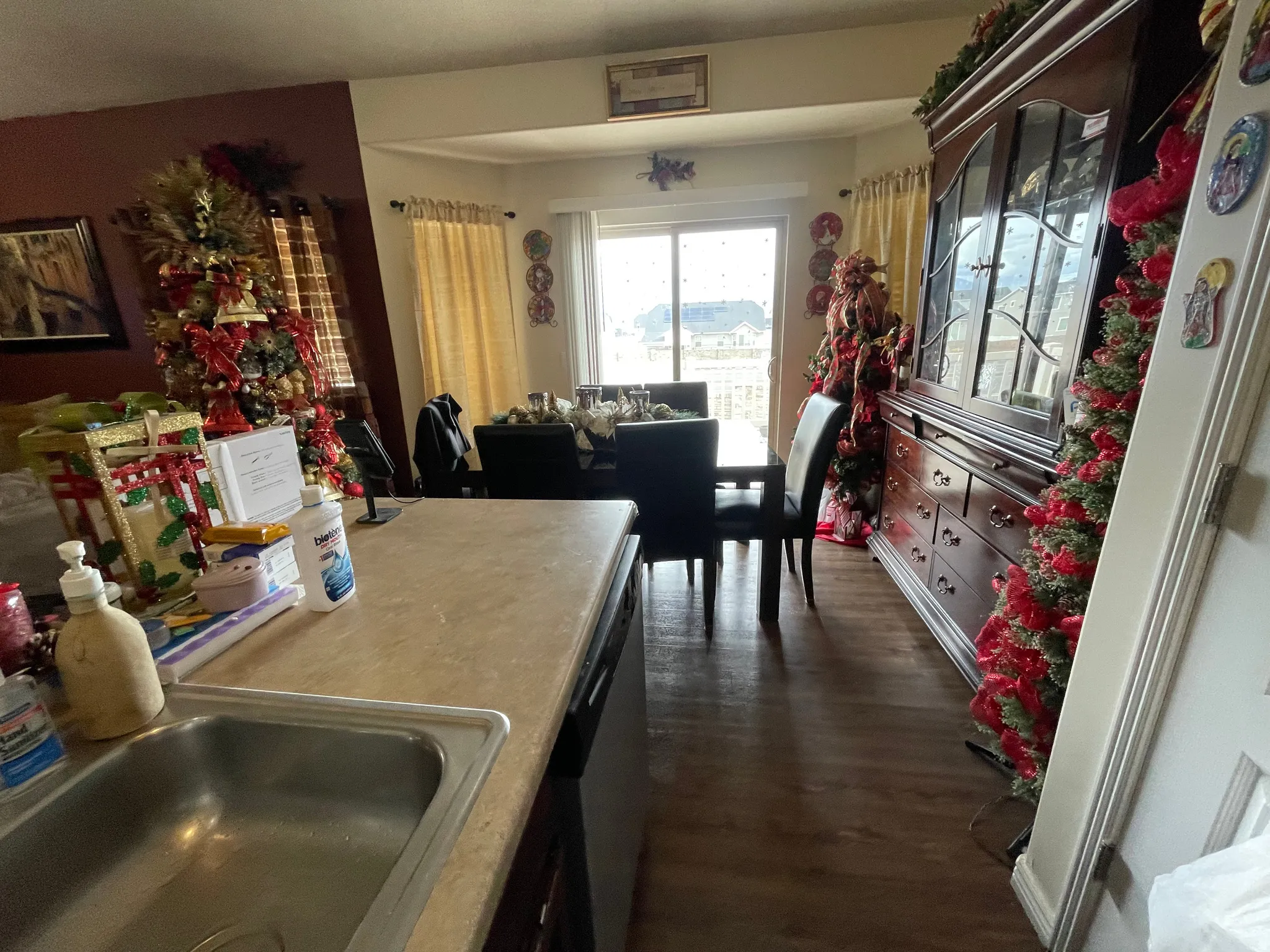 Kitchen featuring dark wood finished floors, light countertops, and dishwasher