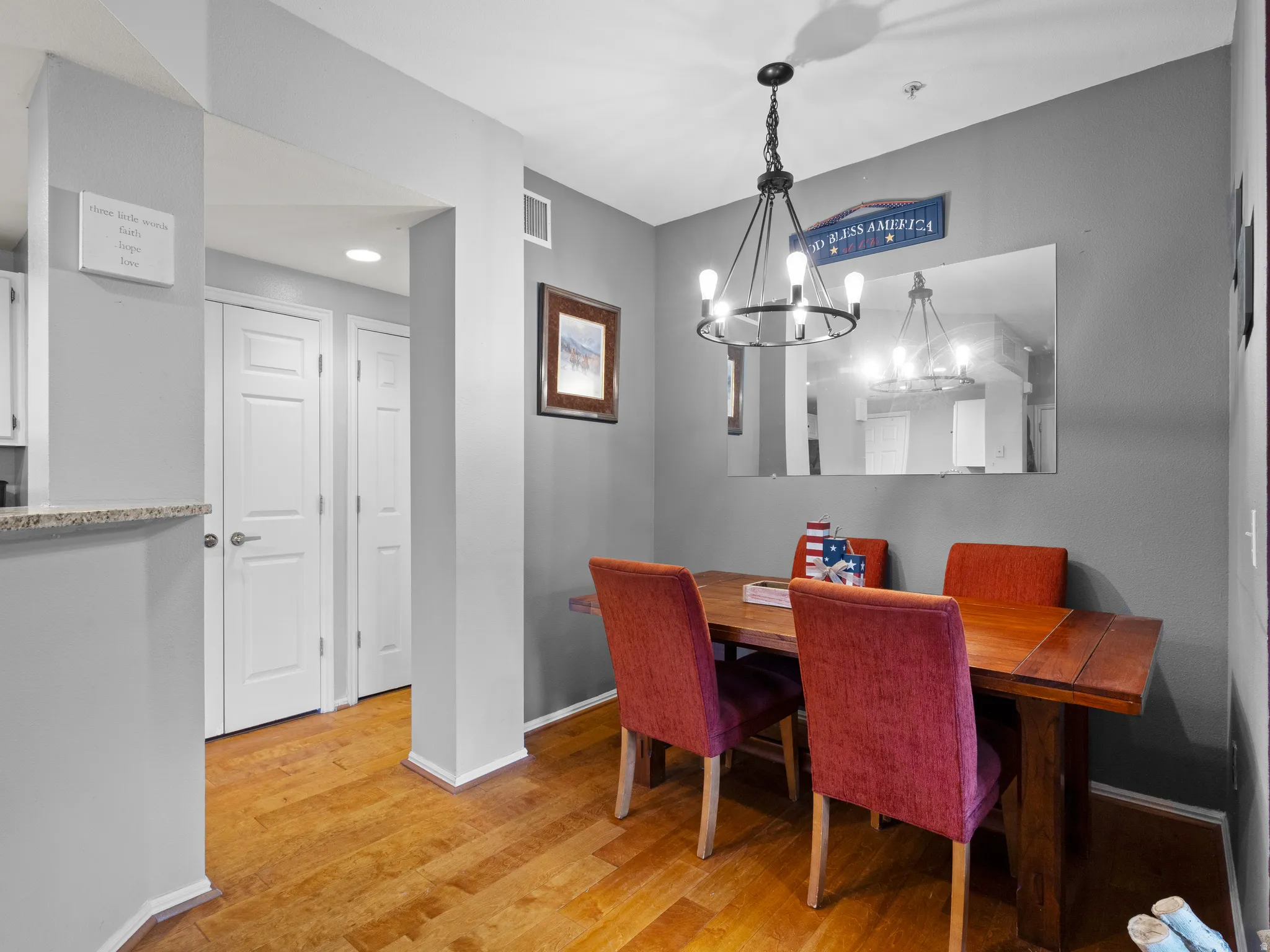 Dining room with light wood finished floors and suspended lighting