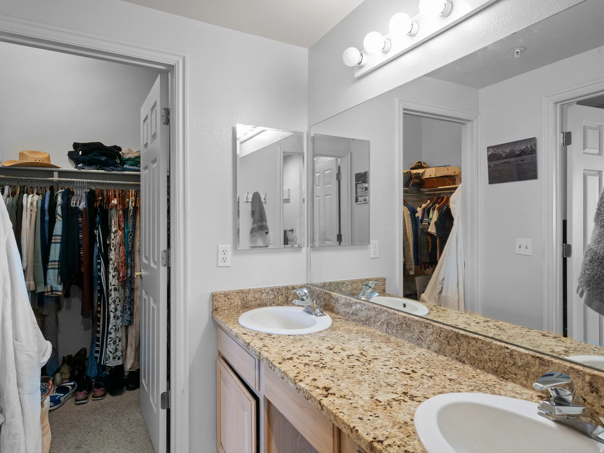 Full bath with a walk in closet and double vanity