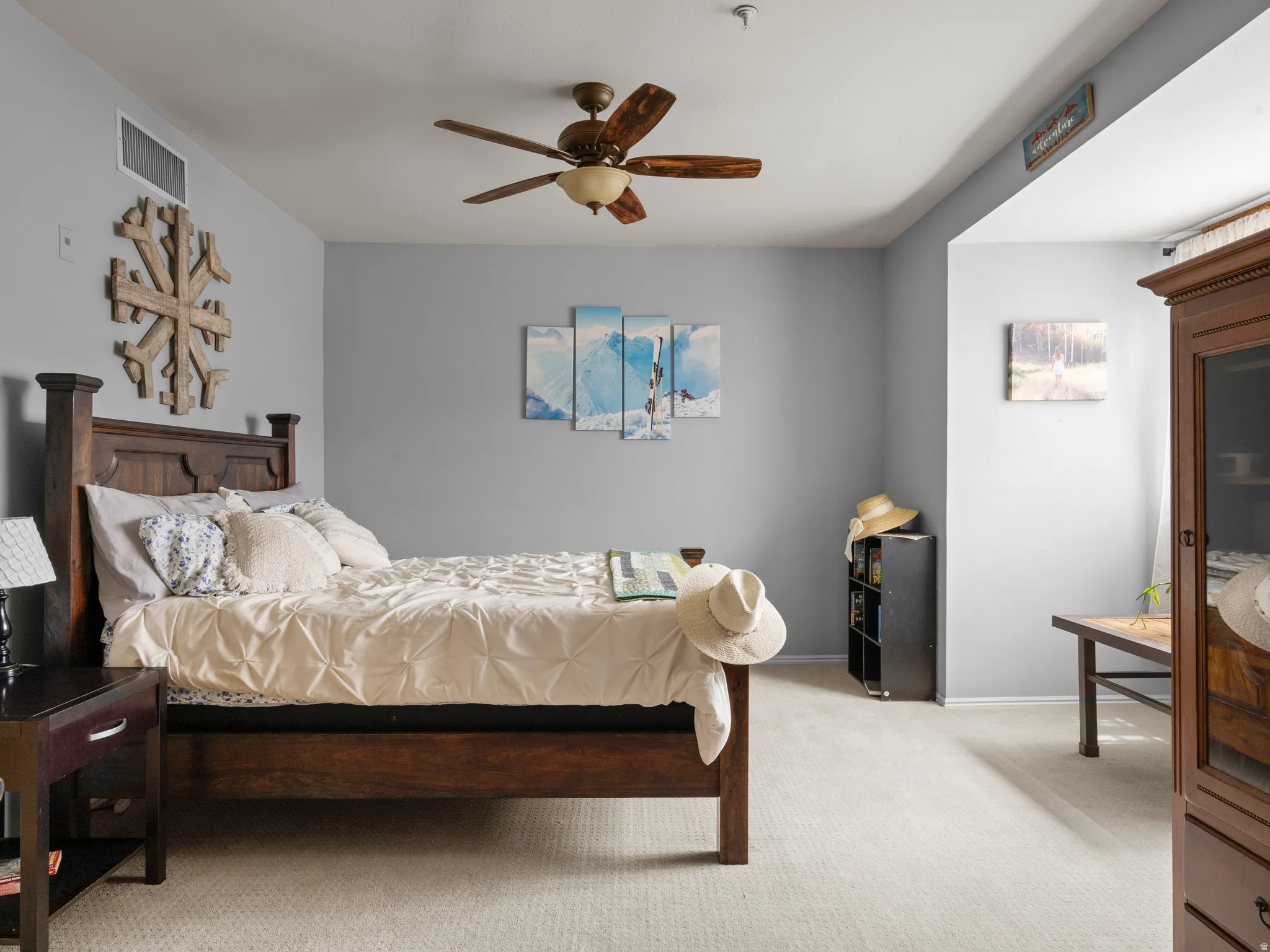 Bedroom featuring light colored carpet and a ceiling fan