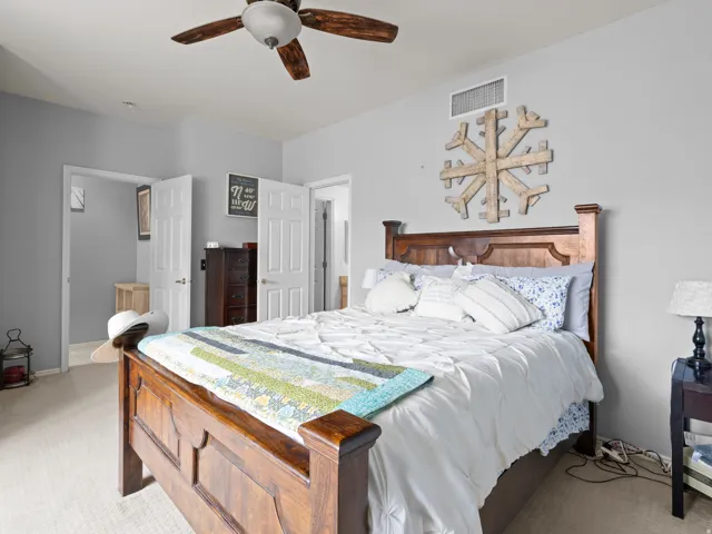 Bedroom featuring light carpet and ceiling fan
