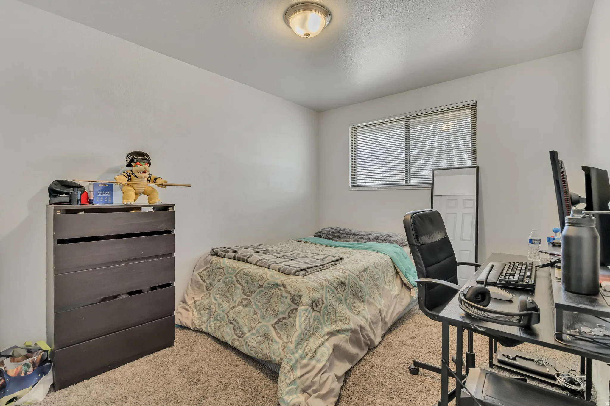 Bedroom featuring carpet flooring and an office area