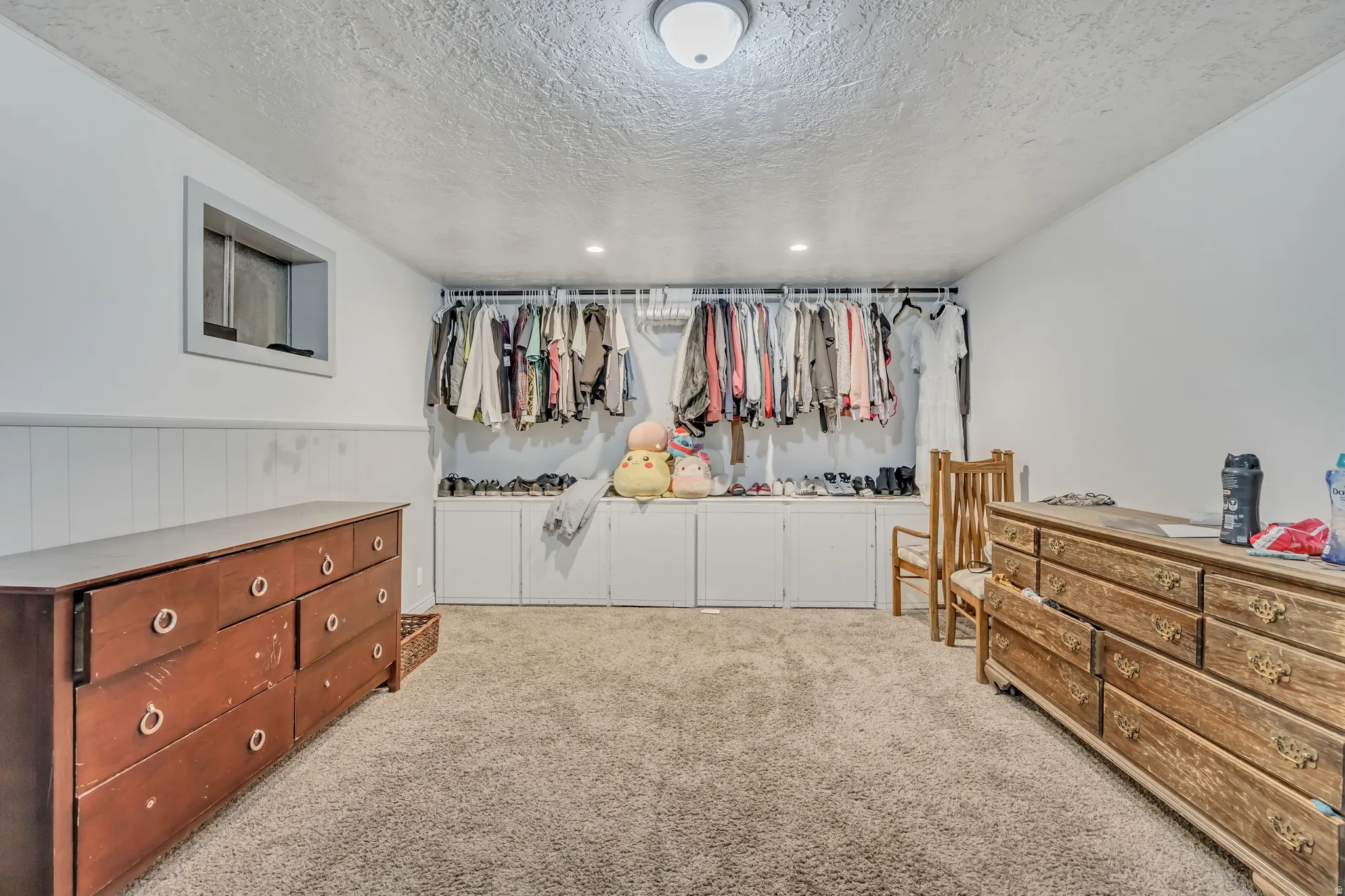 Walk in closet featuring light carpet