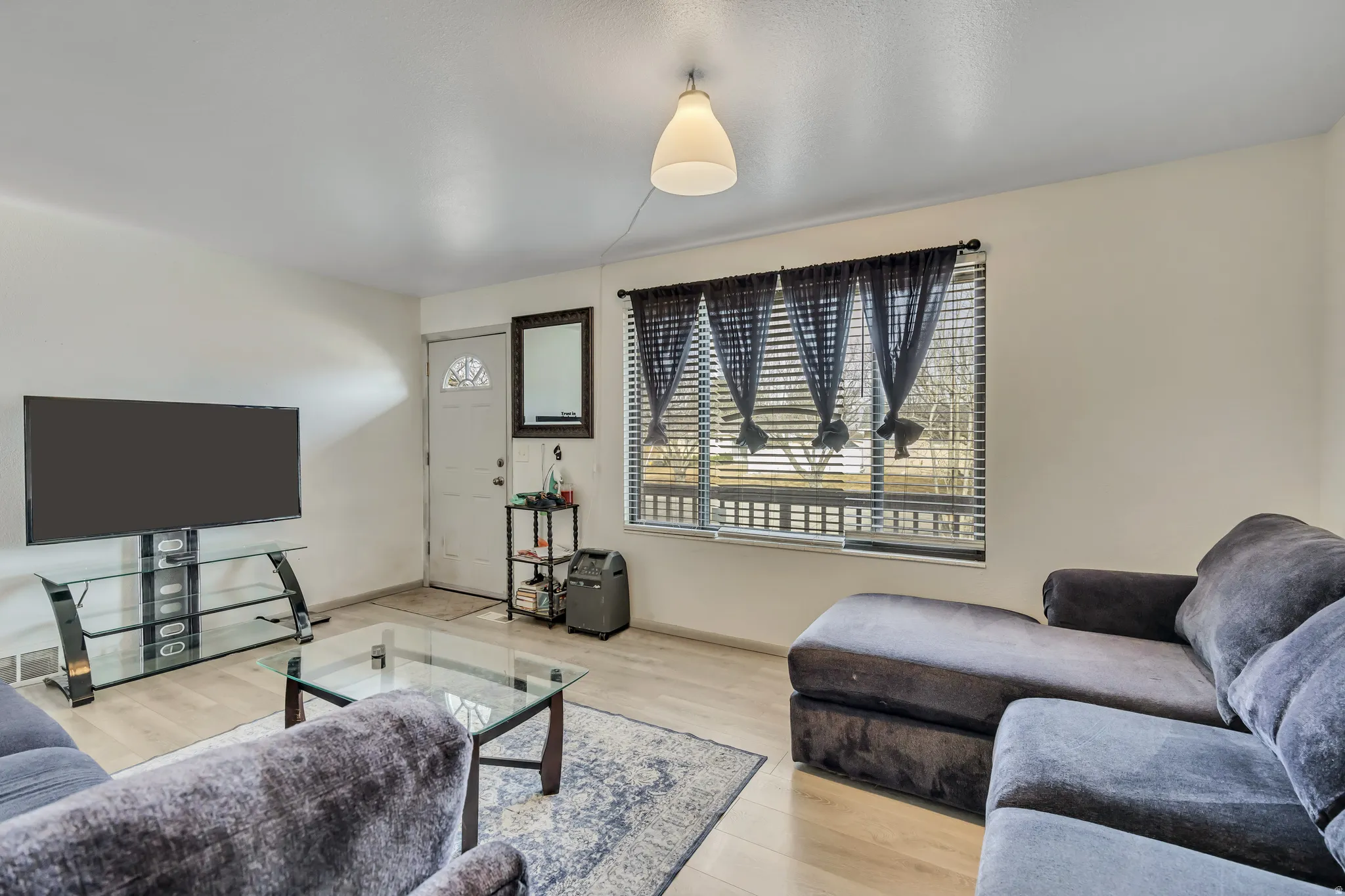 Living area with light wood-type flooring and baseboards