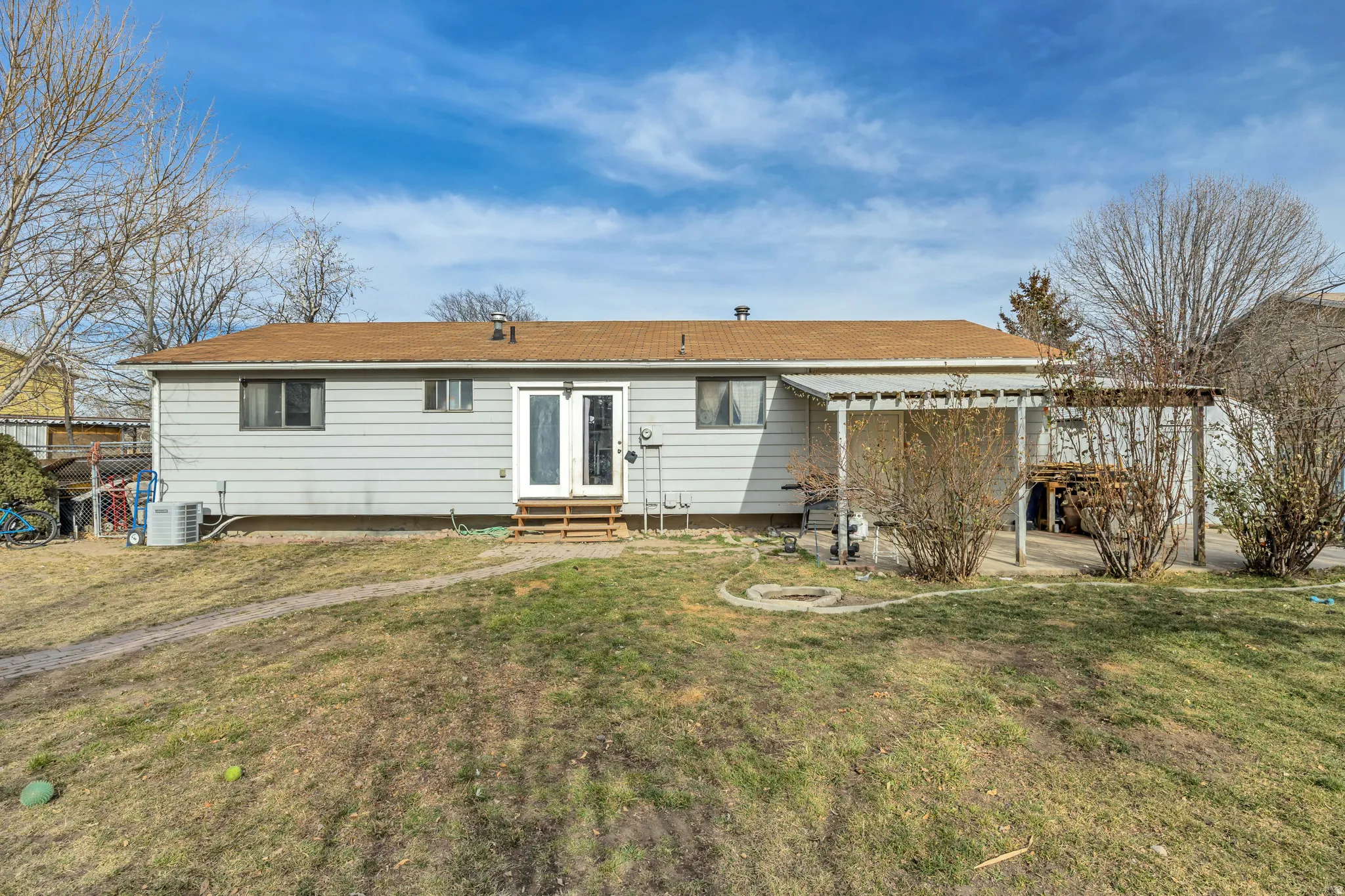 Back of property featuring a yard and entry steps