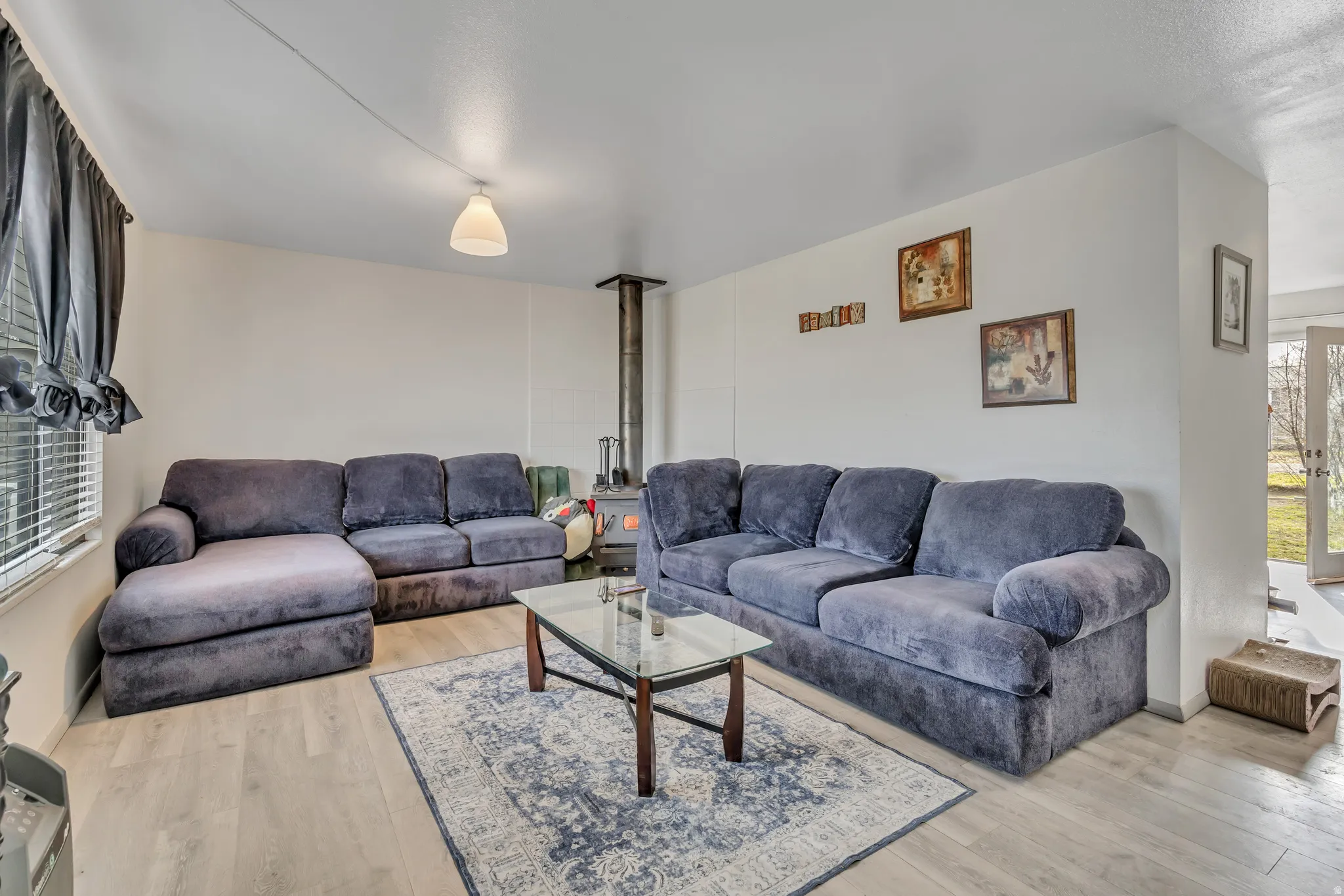 Living room with light wood-style flooring and baseboards
