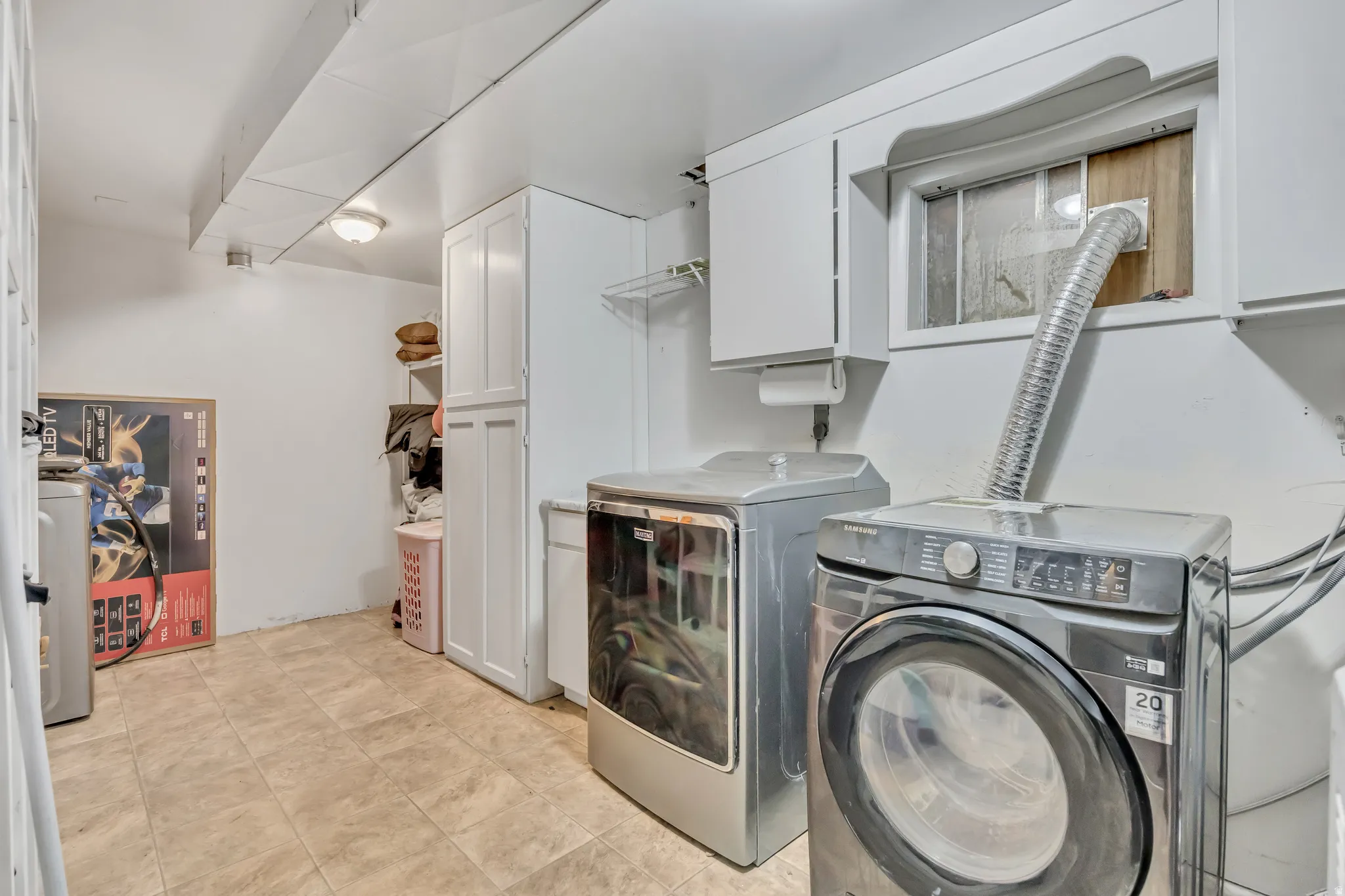 Laundry room featuring cabinet space and washer and clothes dryer