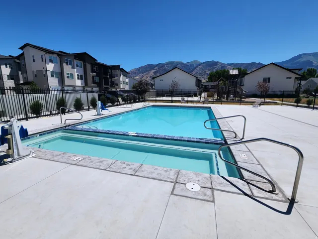 Community pool with a patio area, a residential view, and a mountain view