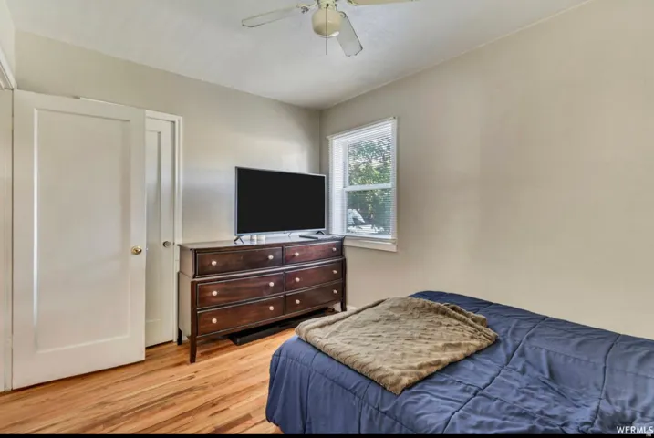 Bedroom featuring light wood-type flooring and ceiling fan