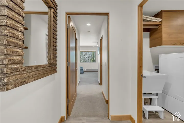 Hallway leading to the primary bedroom which is located on it's own private level of the home