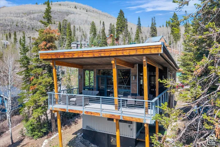 Private covered deck at back of the home with the perfect view of the mountains
