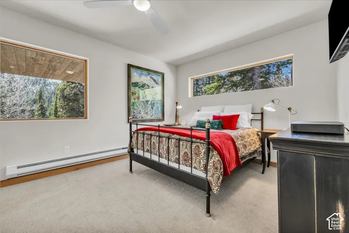 Primary primary suite featuring large windows and a private covered deck prewired for a hot tub