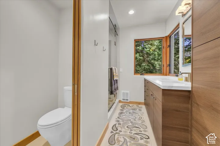 Primary bathroom featuring a custom walk in steam shower