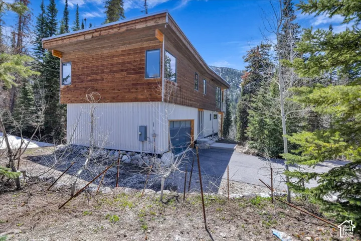 View of side of property with a garage