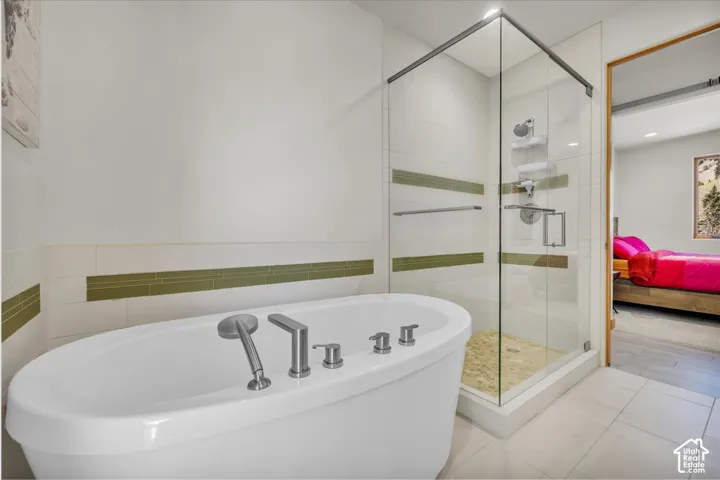 Guest bathroom featuring a separate walk in shower and freestanding soaker tub
