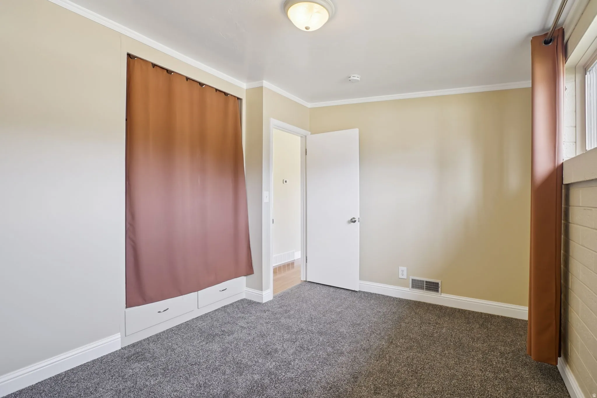 Unfurnished bedroom featuring carpet floors and ornamental molding