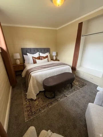 Carpeted bedroom with crown molding