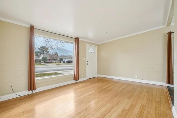 Entrance foyer featuring light wood-type flooring and crown molding