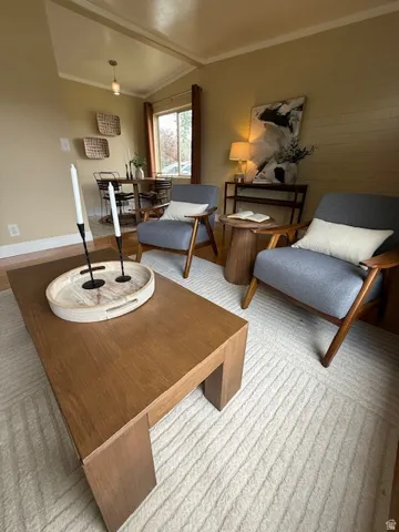 Sitting room with ornamental molding and baseboards