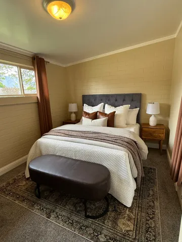 Carpeted bedroom featuring baseboards and ornamental molding