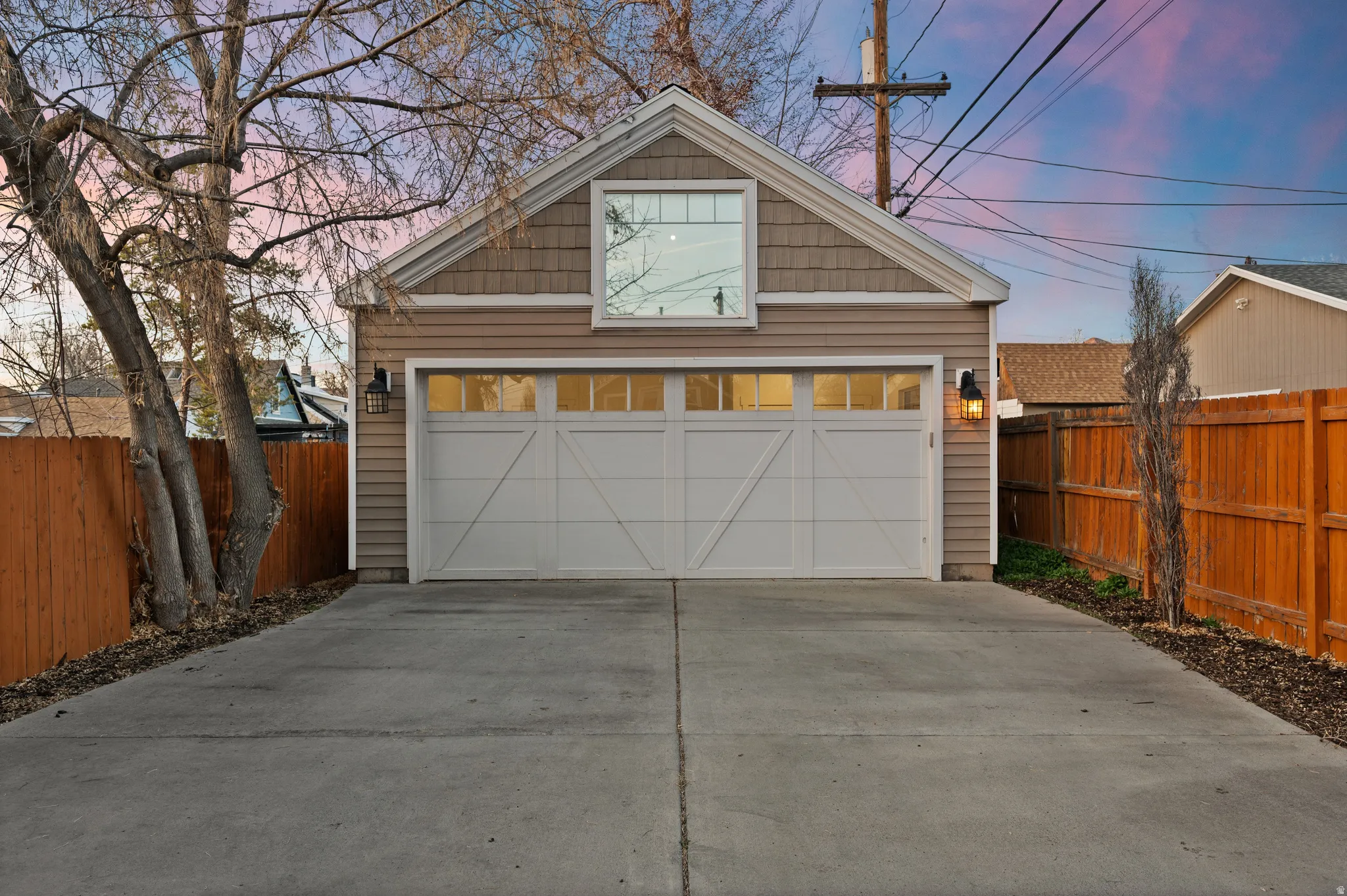 Garage at dusk featuring a garage