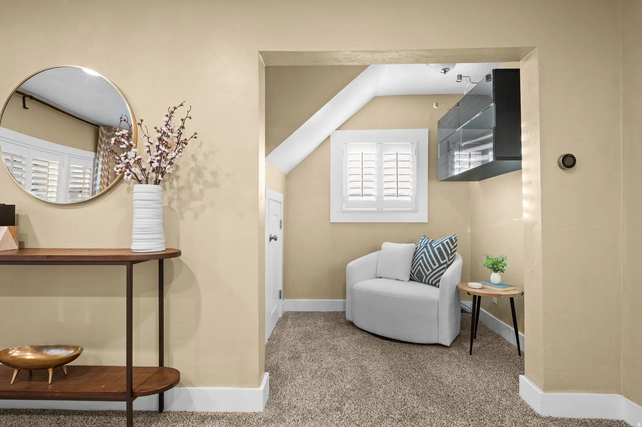 Sitting room featuring carpet and vaulted ceiling