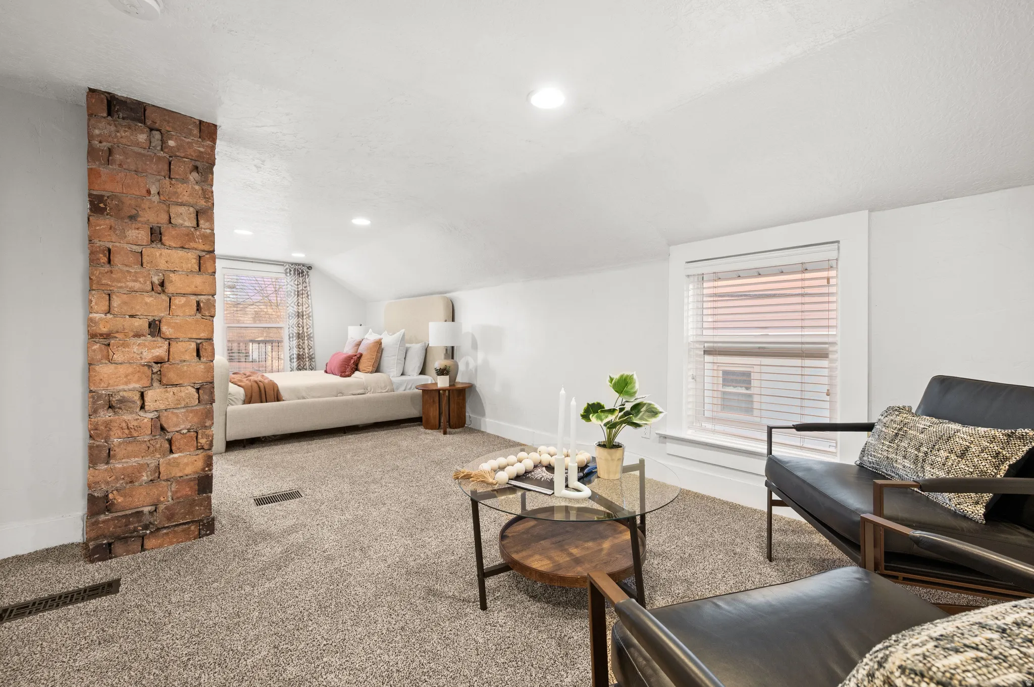 Carpeted bedroom with vaulted ceiling and recessed lighting