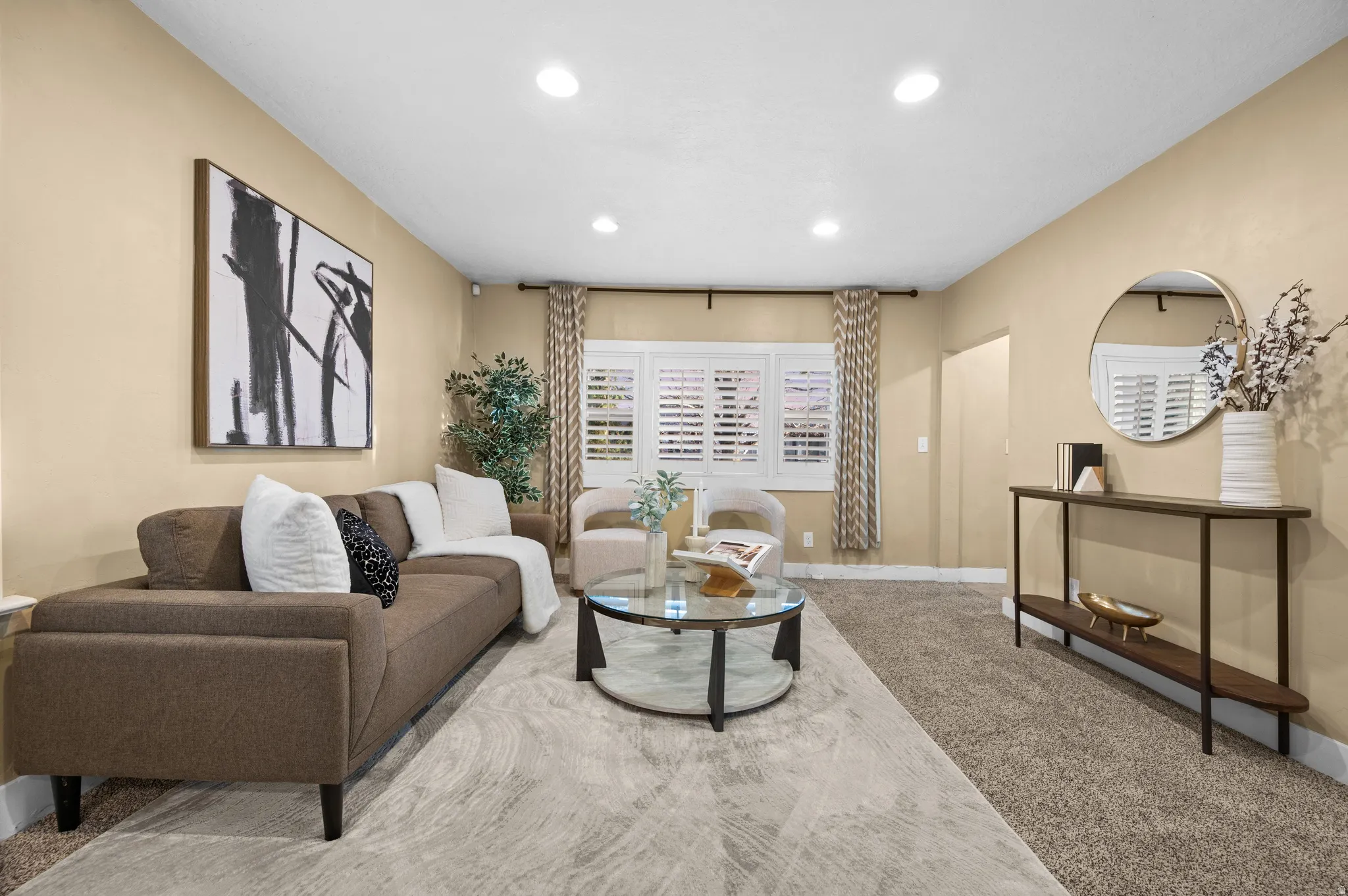Carpeted living area with baseboards and recessed lighting
