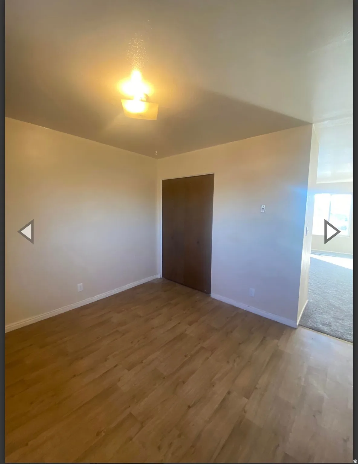 Unfurnished bedroom with wood finished floors and a closet